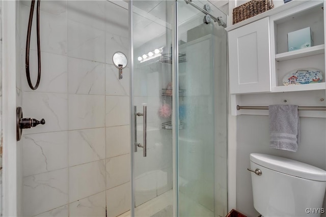 full bathroom with a stall shower and toilet