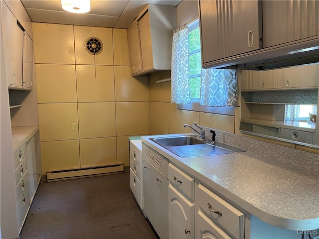 kitchen featuring tile walls, a baseboard radiator, backsplash, and sink