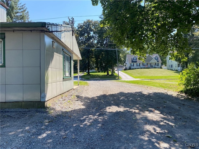 view of side of home featuring a yard