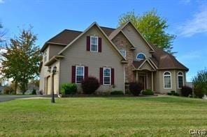 traditional-style home with driveway and a front lawn