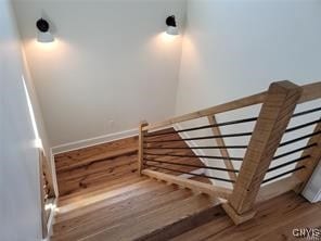 stairs featuring hardwood / wood-style flooring