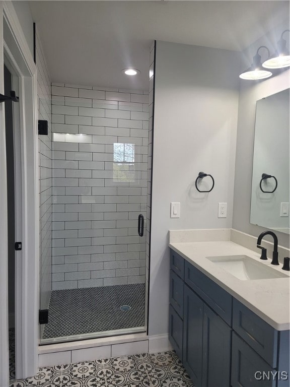 bathroom with vanity, an enclosed shower, and tile patterned flooring