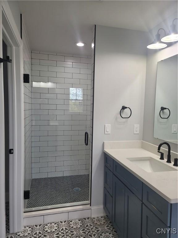 full bathroom with tile patterned flooring, vanity, and a stall shower