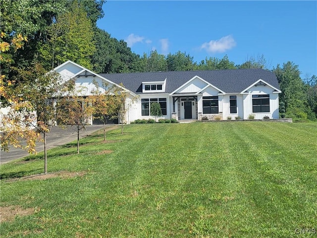view of front of property with driveway, a garage, and a front lawn