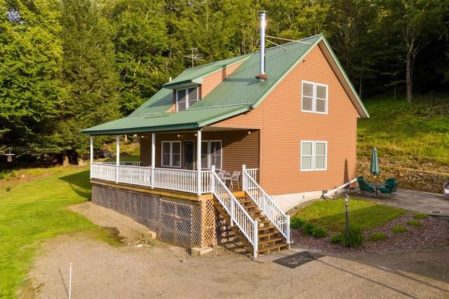 1090 Park Hill Rd, Colchester, NY 13755 - view of front facade featuring a porch, a view of trees, and stairway
