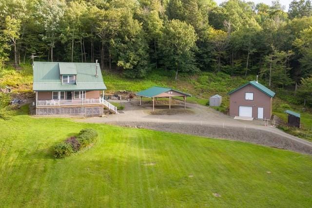 1090 Park Hill Rd, Colchester, NY 13755 - exterior space with a detached carport, a porch, a view of trees, driveway, and a detached garage