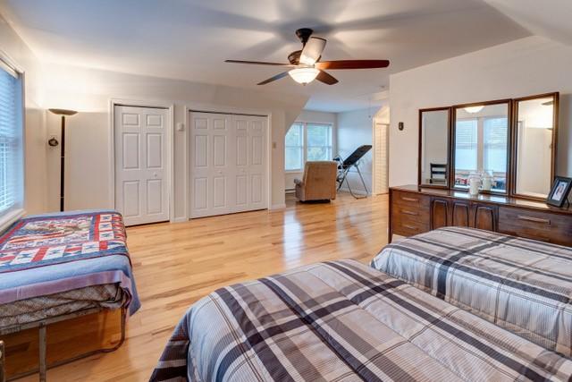 1090 Park Hill Rd, Colchester, NY 13755 - bedroom featuring multiple closets, a ceiling fan, and light wood-style flooring