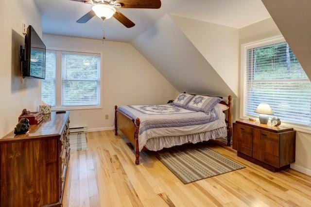 1090 Park Hill Rd, Colchester, NY 13755 - bedroom featuring ceiling fan, light wood-style flooring, baseboards, a baseboard radiator, and vaulted ceiling