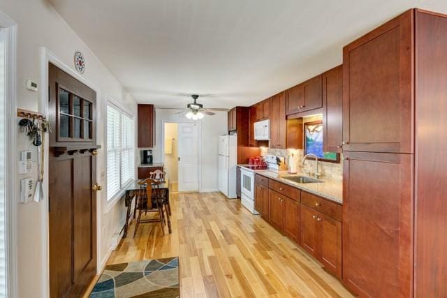 1090 Park Hill Rd, Colchester, NY 13755 - kitchen featuring a sink, light wood-style floors, white appliances, a ceiling fan, and tasteful backsplash
