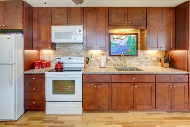 1090 Park Hill Rd, Colchester, NY 13755 - kitchen with decorative backsplash, light stone countertops, a sink, light wood-style floors, and white appliances
