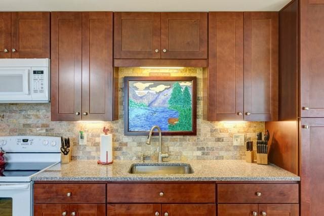 1090 Park Hill Rd, Colchester, NY 13755 - kitchen featuring brown cabinetry, white appliances, light stone countertops, a sink, and backsplash