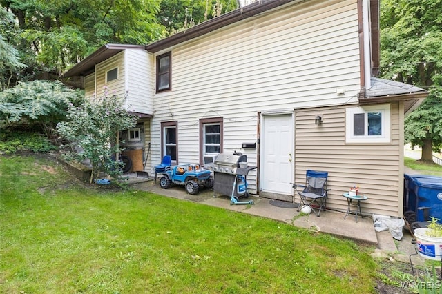 rear view of property with a lawn