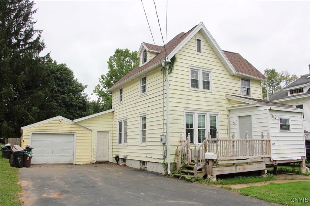 view of front of property with a garage and an outbuilding