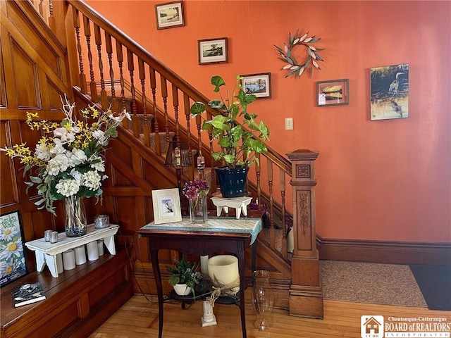 staircase with hardwood / wood-style floors