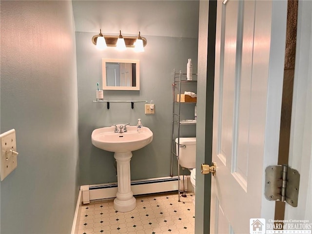 bathroom featuring toilet and baseboard heating