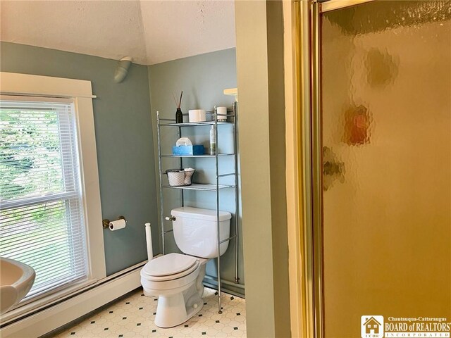 bathroom featuring a baseboard radiator, an enclosed shower, and toilet