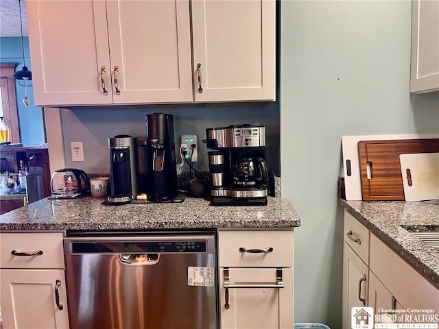 kitchen featuring light stone counters, stainless steel dishwasher, and white cabinets