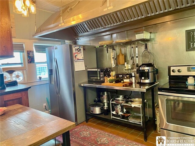 kitchen with stainless steel appliances and dark tile patterned flooring