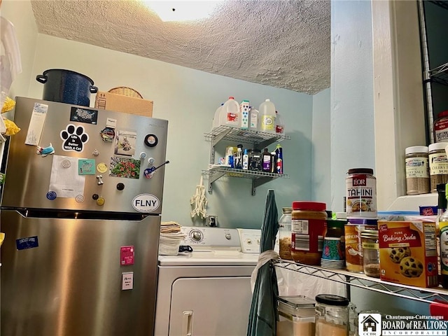 laundry room with washer / dryer and a textured ceiling