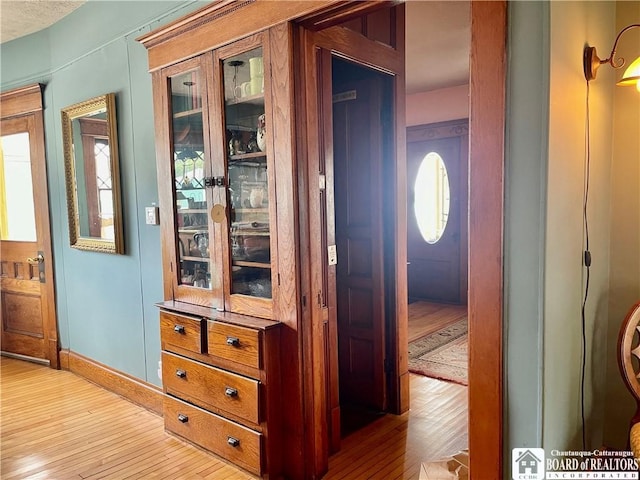 hallway with light hardwood / wood-style flooring