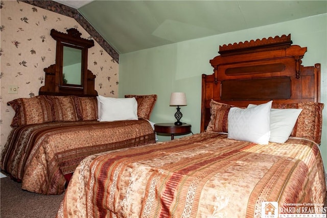 carpeted bedroom with lofted ceiling