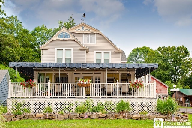 rear view of property with covered porch