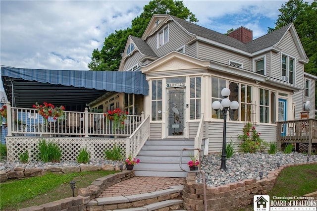 view of front of house featuring a sunroom