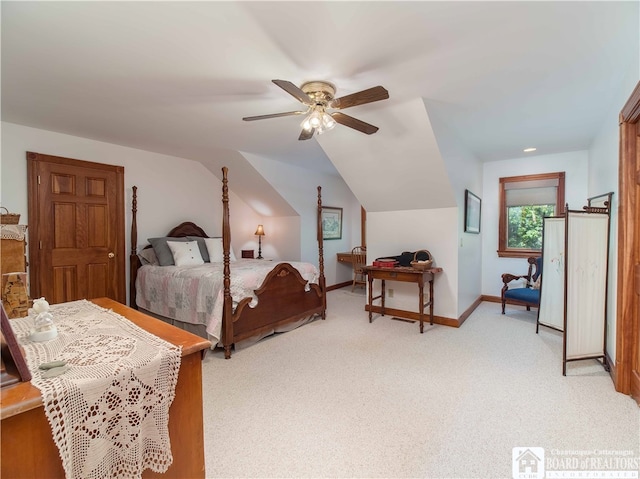 carpeted bedroom with ceiling fan and vaulted ceiling