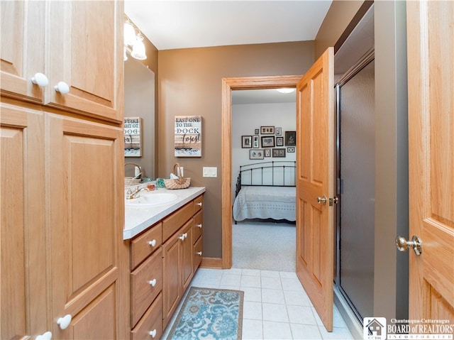 bathroom featuring tile patterned floors, a shower with door, and vanity