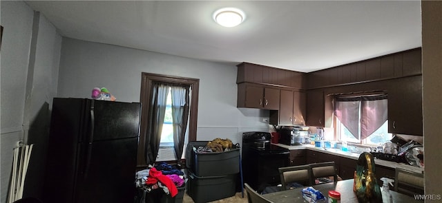 kitchen with black appliances and dark brown cabinets