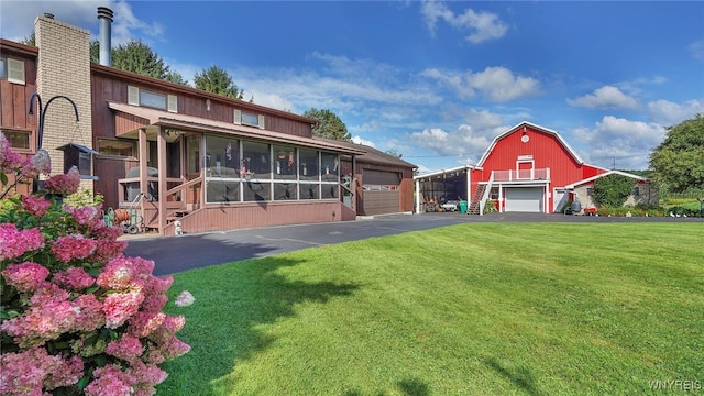 exterior space featuring a garage and a lawn