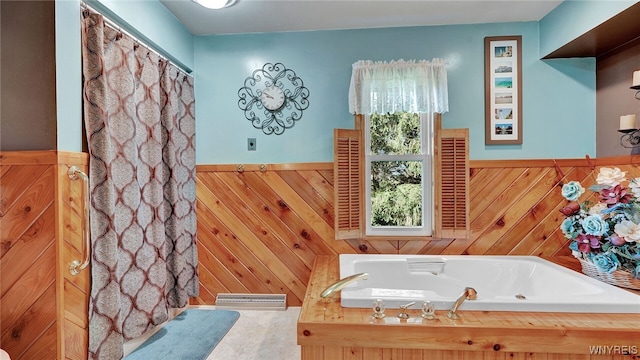 bathroom featuring separate shower and tub and wooden walls