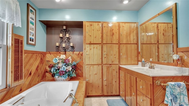 bathroom with vanity, a bathing tub, wood walls, and tile patterned floors