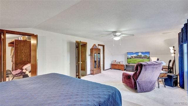 carpeted bedroom with vaulted ceiling, a textured ceiling, and ceiling fan