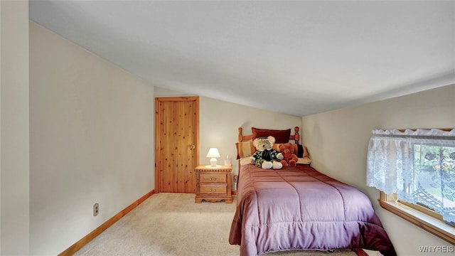 bedroom featuring vaulted ceiling and carpet floors