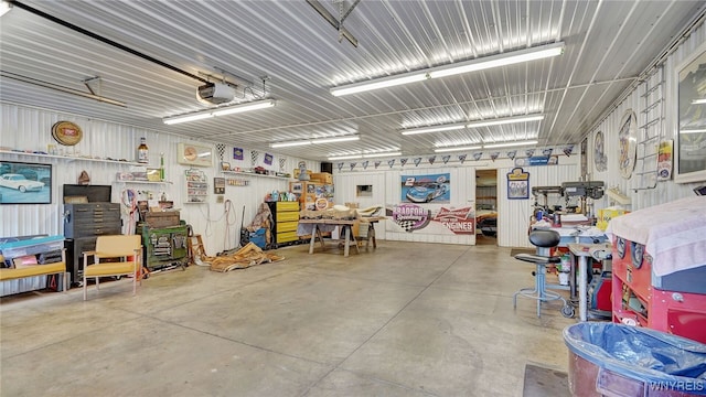 garage featuring a garage door opener and a workshop area