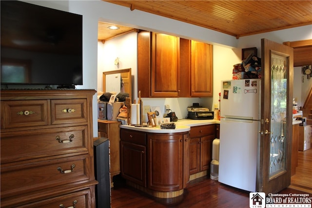 kitchen with dark hardwood / wood-style floors, wood ceiling, ornamental molding, and white fridge