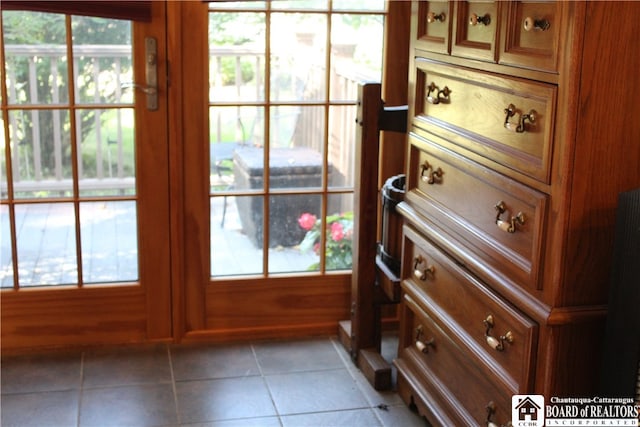 entryway with a healthy amount of sunlight and tile patterned floors