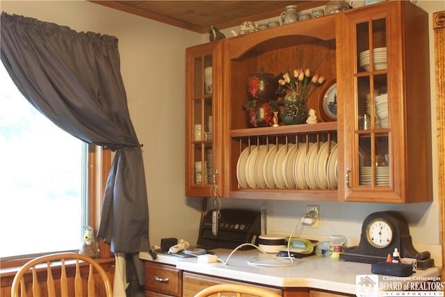 222 Seymour St, Pomfret, NY 14063 - kitchen with light countertops, glass insert cabinets, brown cabinetry, and wood ceiling