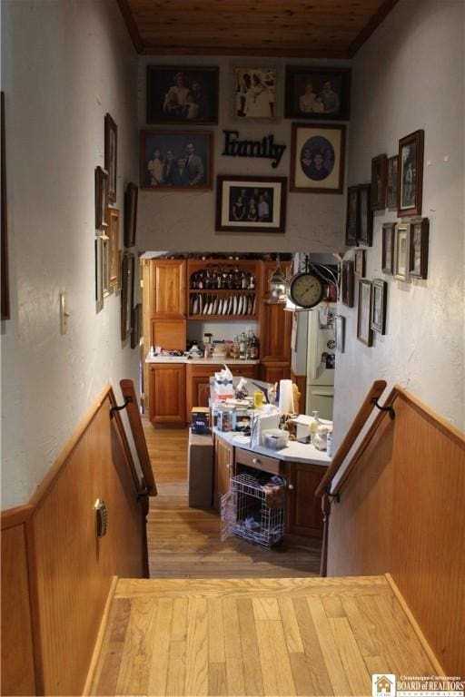 222 Seymour St, Pomfret, NY 14063 - bar area featuring light wood-type flooring, wainscoting, wooden ceiling, and wood walls