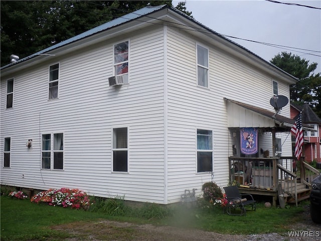 view of property exterior with a yard and a deck