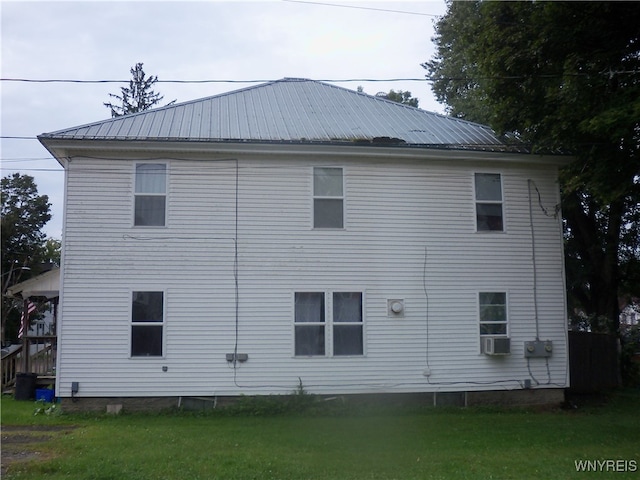 view of side of property with a lawn