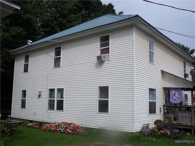 view of property exterior featuring a lawn and cooling unit