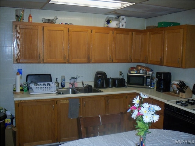 kitchen featuring white gas range and sink