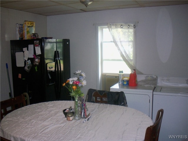 dining room featuring washing machine and clothes dryer and a drop ceiling