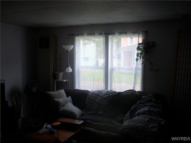 living room with plenty of natural light and a paneled ceiling