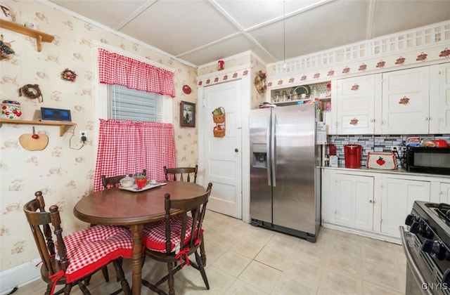 kitchen with appliances with stainless steel finishes, white cabinetry, and decorative backsplash