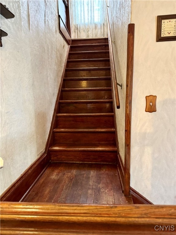 stairs featuring hardwood / wood-style floors