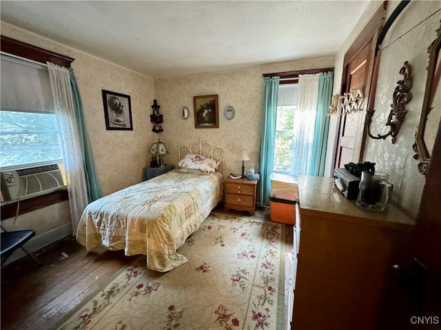 bedroom with a textured ceiling, light hardwood / wood-style flooring, and cooling unit