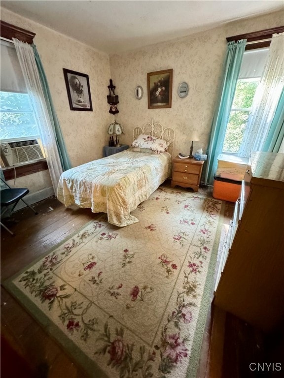 bedroom featuring cooling unit and hardwood / wood-style flooring